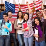 Happy students presenting their country with flags